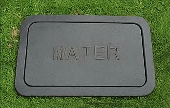 Outdoor water meter box near curb